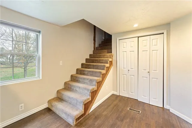 a view of entryway with wooden floor and stairs