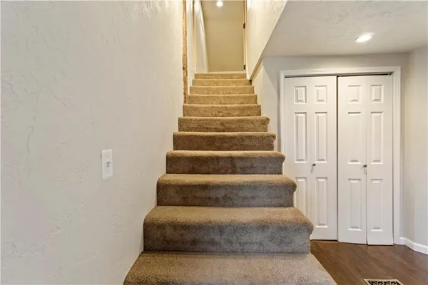 a view of staircase with white walls