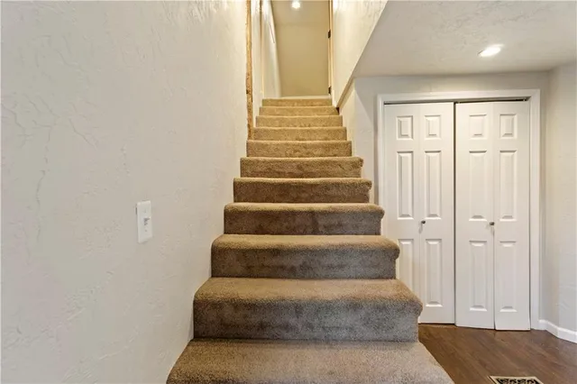 a view of staircase with white walls