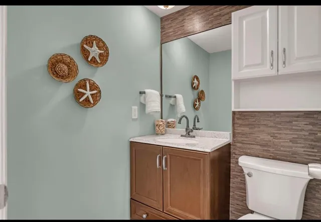 a bathroom with a sink a vanity and mirror