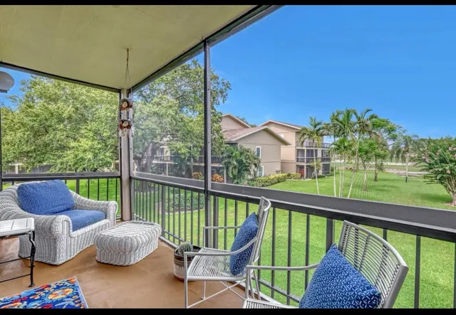 a view of a chair and tables in the balcony