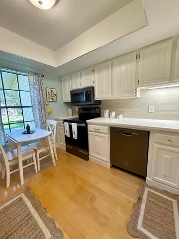 a kitchen with a sink cabinets and window