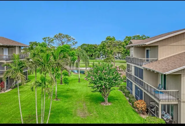 a backyard of a house with plants and outdoor seating