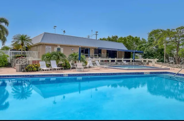 a swimming pool view with a outdoor seating