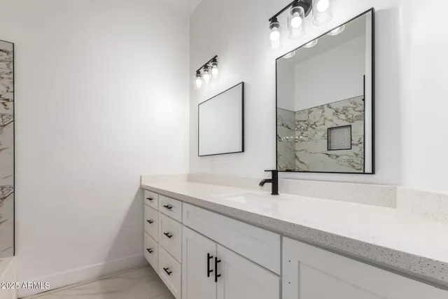 a bathroom with a sink and a mirror