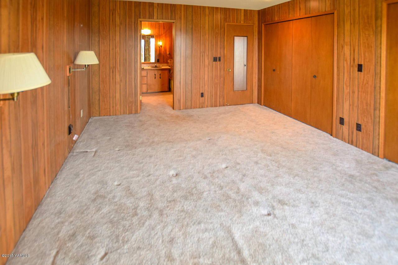 583 Ragan Road Wapato, WA 98951 - Photo 14 of 31 a view of a hallway with wooden shelves