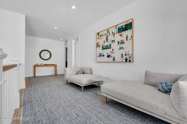 a bathroom with a bathtub shower sink mirror and toilet