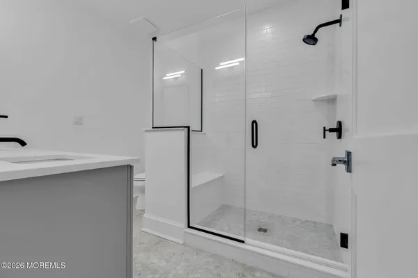 a spacious bathroom with a sink and a mirror