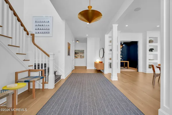 a view of a hallway view with wooden floor and furniture