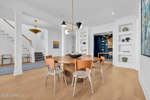 a dining room with furniture and wooden floor