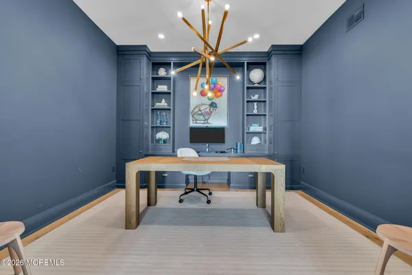 a view of a room with wooden floor and chandelier