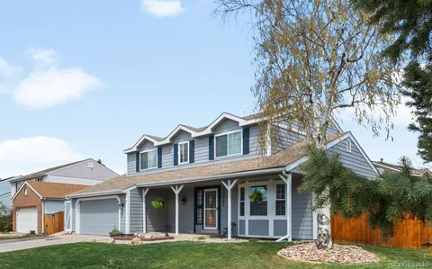 front view of a brick house with a yard
