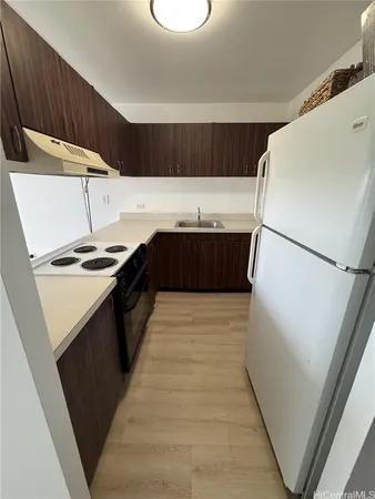 a kitchen with a refrigerator and a stove