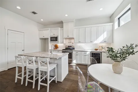a kitchen with a table and chairs in it