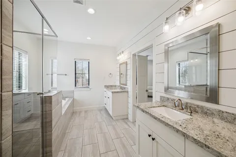 a bathroom with a granite countertop sink mirror and double