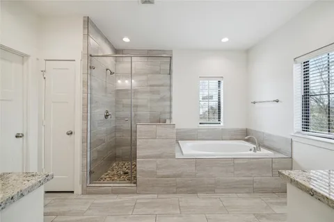 a bathroom with a bathtub and a shower