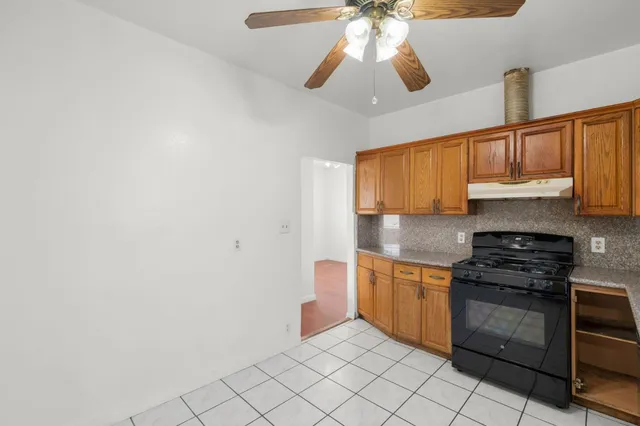 a kitchen with stainless steel appliances a stove cabinets and microwave