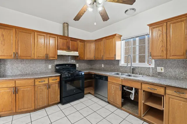 a kitchen with stainless steel appliances granite countertop a sink and cabinets