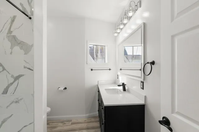 a bathroom with a sink vanity and a mirror