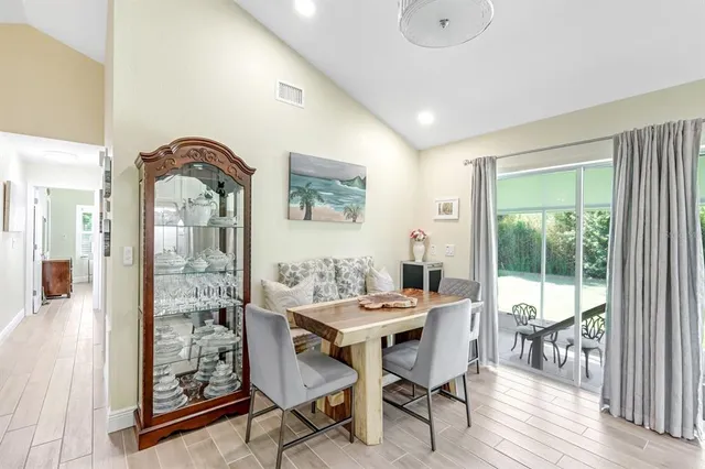 a dining room with furniture and wooden floor