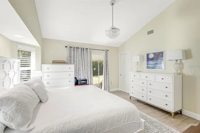 a bedroom with a bed and ceiling fan