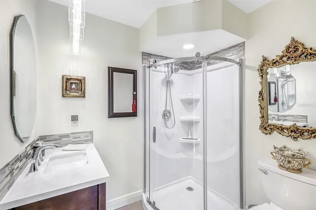 a bathroom with a shower sink and mirror