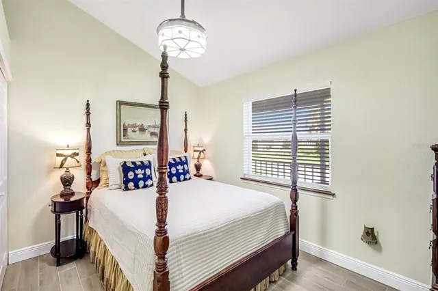 a bedroom with bed and a chandelier