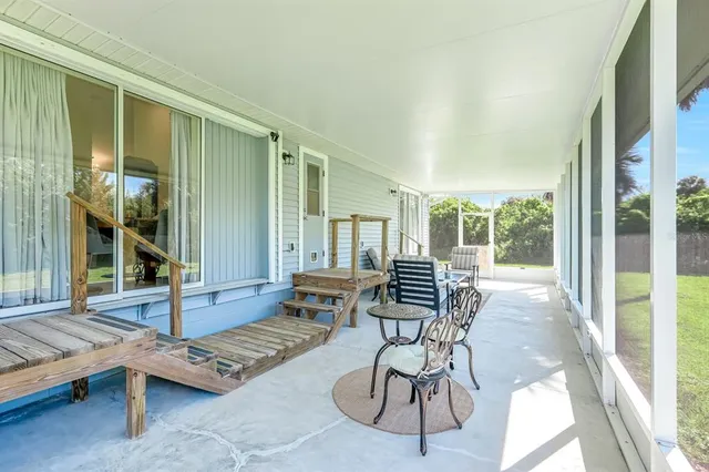 a building outdoor space with patio furniture and potted plants