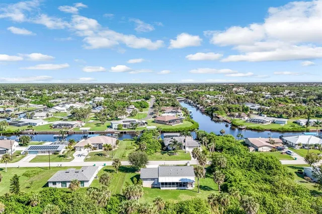 an aerial view of residential house with outdoor space and trees