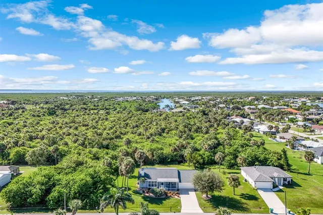 an aerial view of a houses with city view