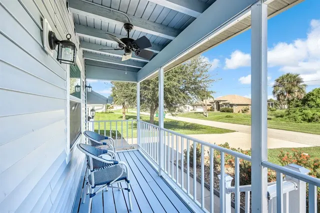 a view of a chairs and table in patio with wooden floor