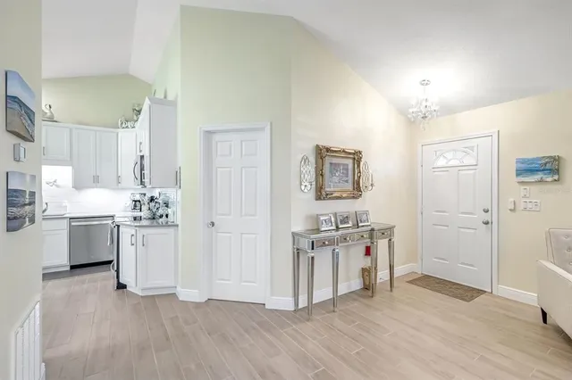a kitchen with a refrigerator and a stove top oven