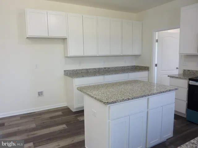 a kitchen with cabinets appliances and a counter space