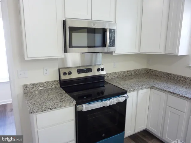 a kitchen with appliances cabinets and a counter top space