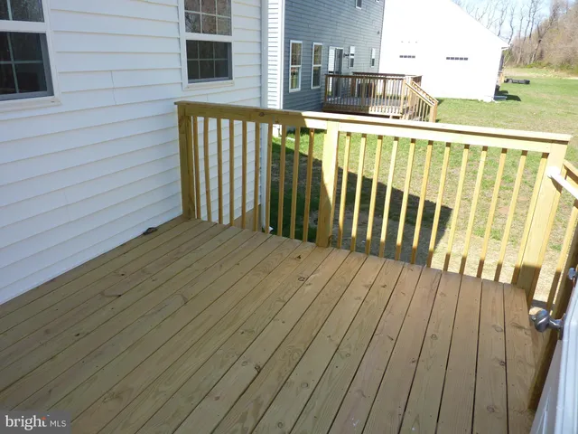 a view of deck with wooden floor and fence