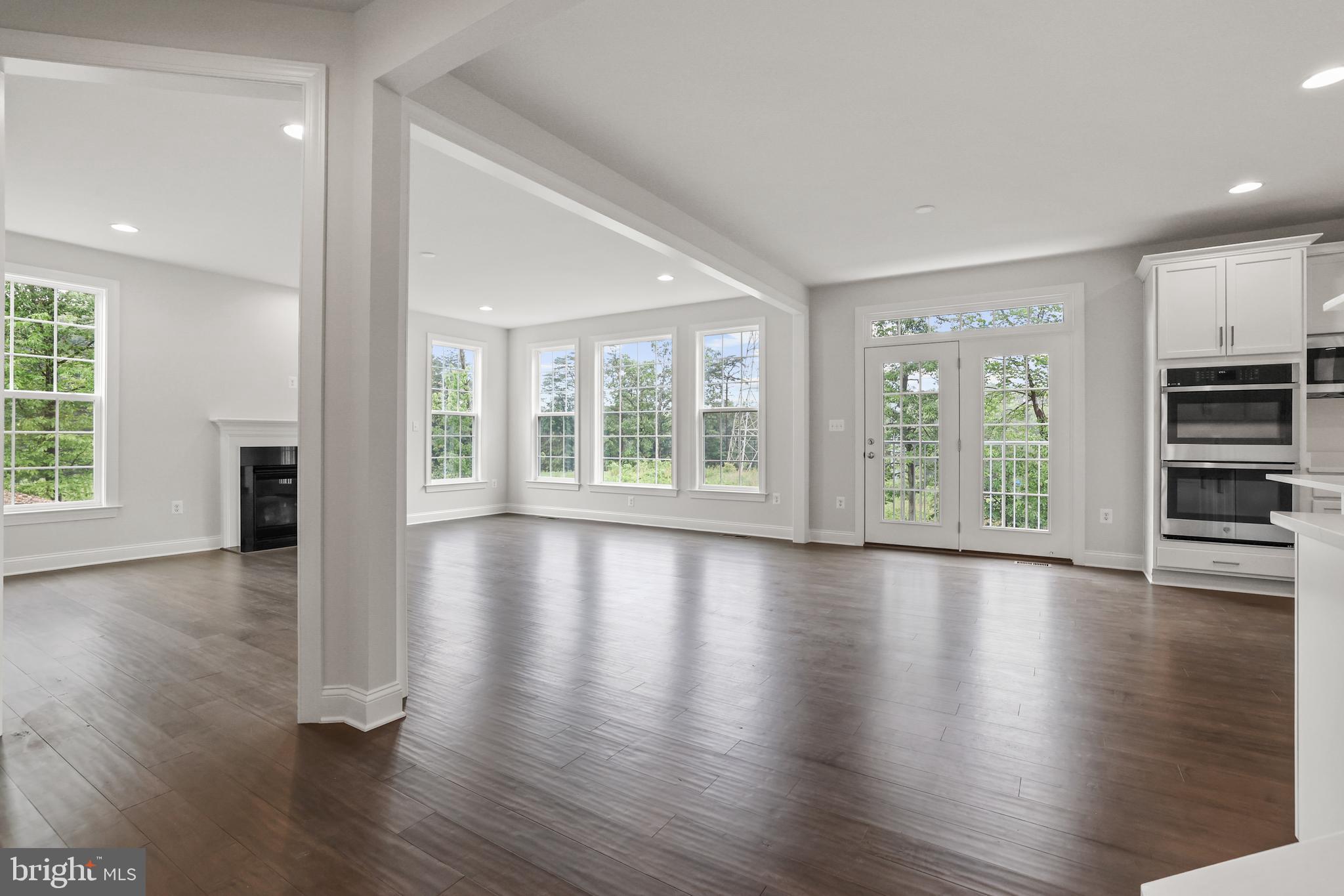14496 Aurora Drive Woodbridge, VA 22193 - Photo 17 of 70 an empty room with wooden floor and windows
