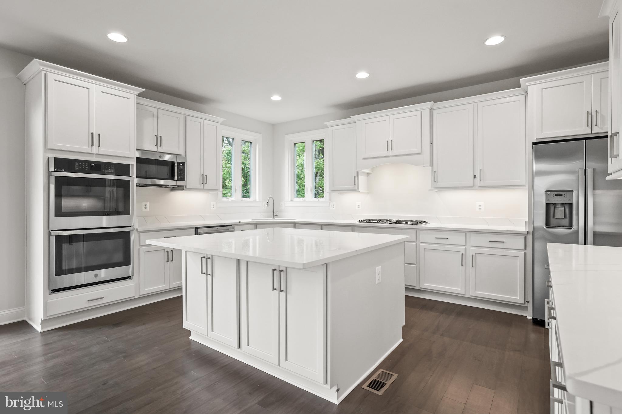 14496 Aurora Drive Woodbridge, VA 22193 - Photo 23 of 70 a kitchen with granite countertop white cabinets and stainless steel appliances