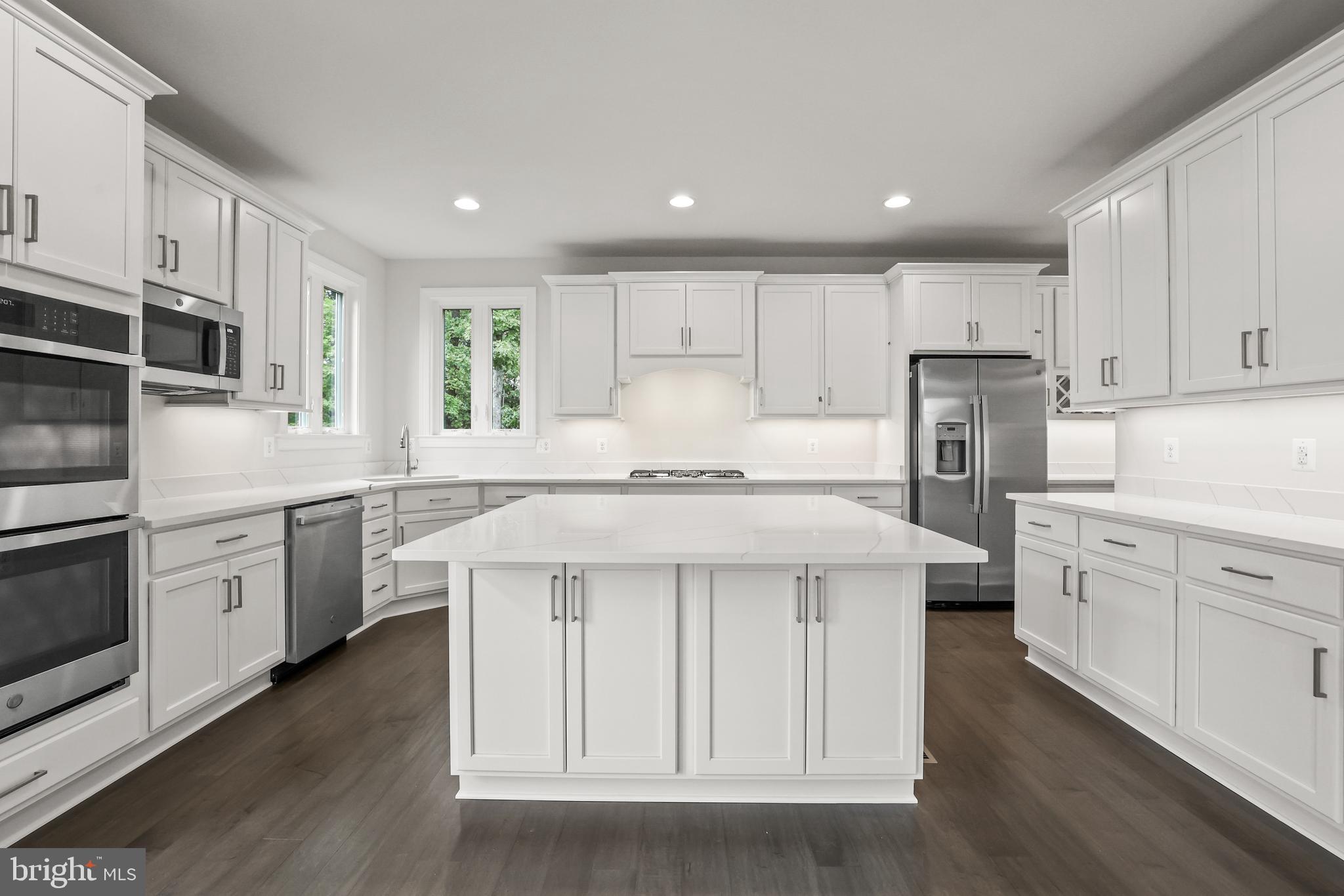 14496 Aurora Drive Woodbridge, VA 22193 - Photo 24 of 70 a kitchen with stainless steel appliances kitchen island granite countertop a stove a sink and white cabinets with wooden floor