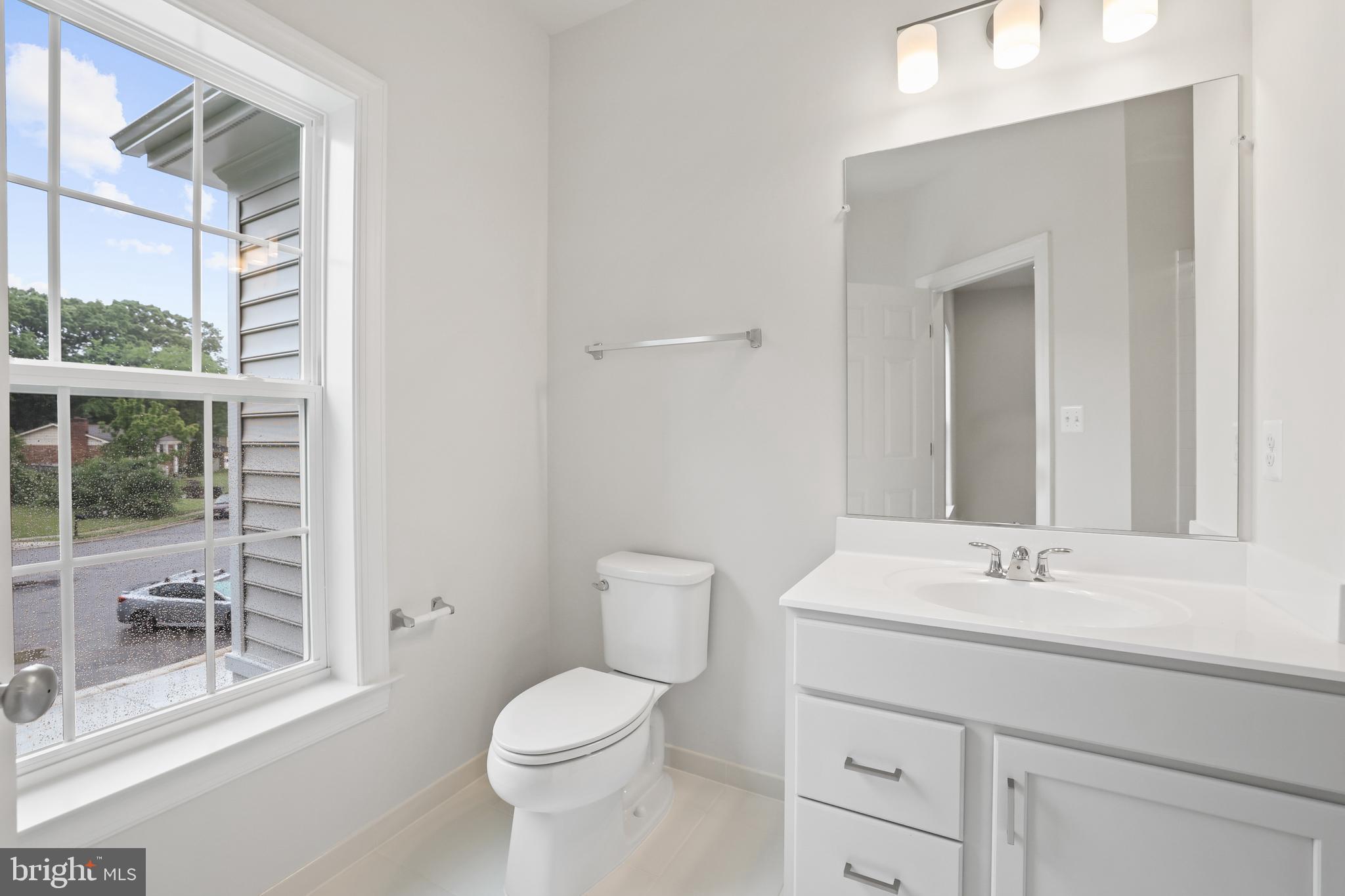 14496 Aurora Drive Woodbridge, VA 22193 - Photo 49 of 70 a bathroom with a toilet a sink a mirror and a shower