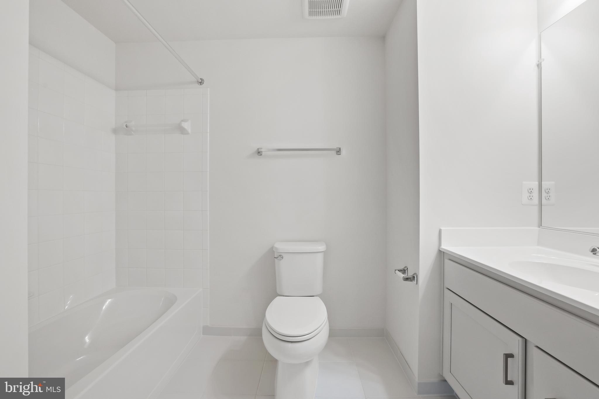 14496 Aurora Drive Woodbridge, VA 22193 - Photo 54 of 70 a white toilet sitting next to a bathroom sink