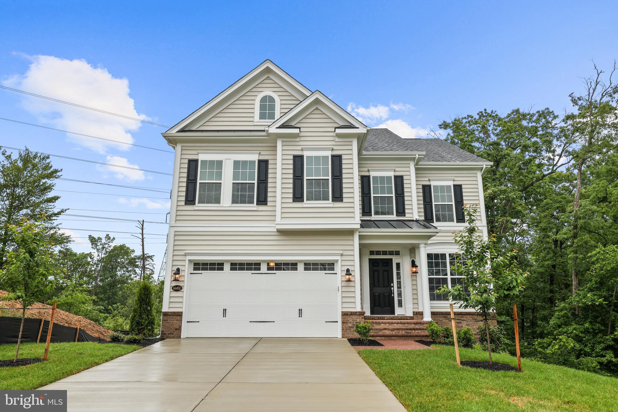 14496 Aurora Drive Woodbridge, VA 22193 - Photo 7 of 70 a front view of a house with a yard