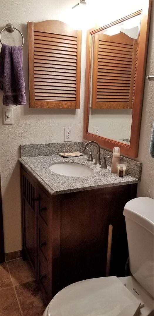 800 Copper Road, Unit 205 Frisco, CO 80443 - Photo 18 of 22 Half bathroom featuring toilet, vanity, and a textured wall