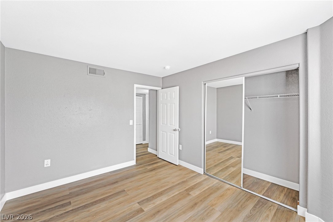 3318 North Decatur Boulevard, Unit 2152 Las Vegas, NV 89130 - Photo 29 of 58 Streamlined mirrored closet doors enhance the spacious feel of this neutral-toned bedroom.