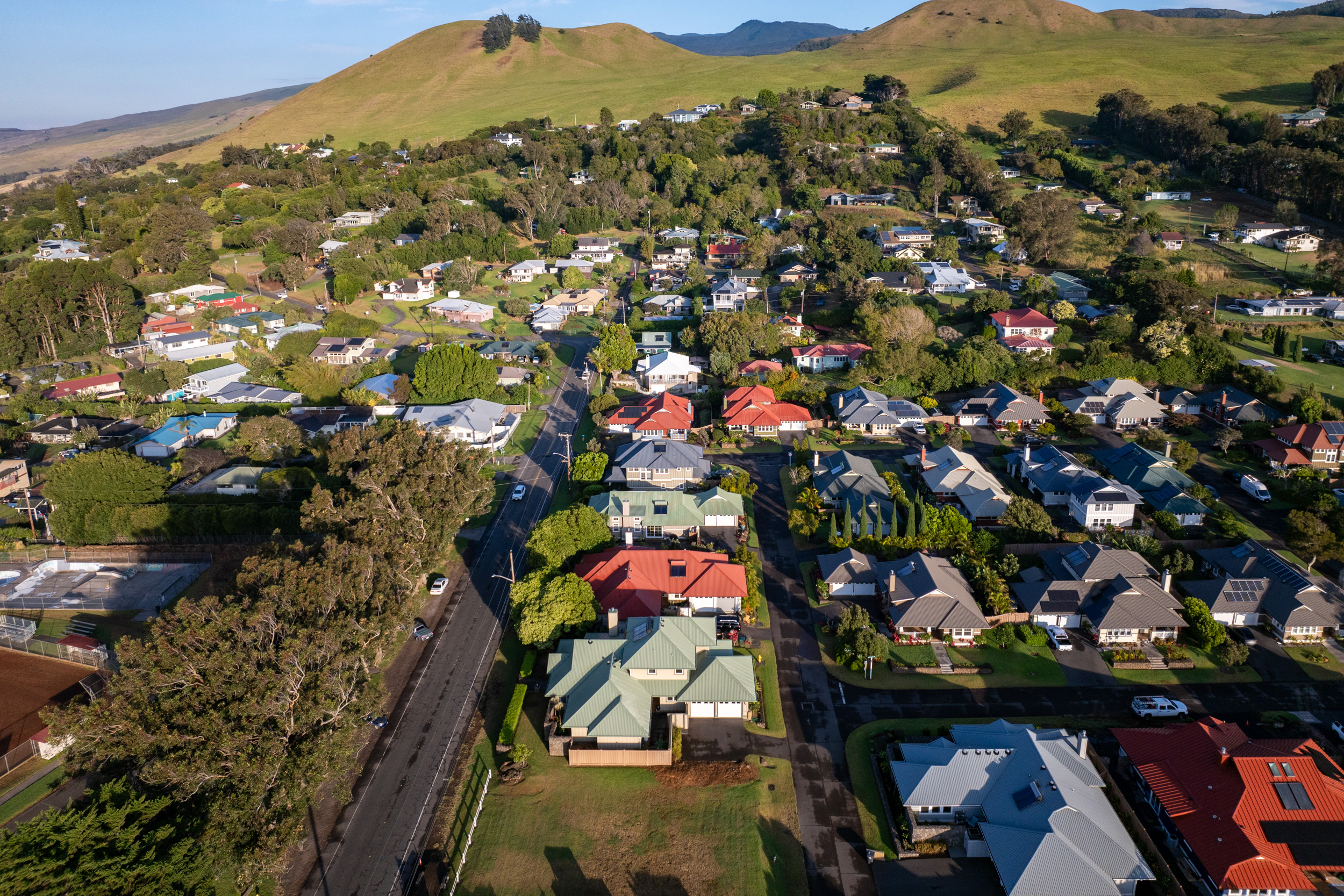 65-1260 Lindsey Road Kamuela, HI 96743 - Photo 4 of 4 an aerial view of residential houses with outdoor space and swimming pool