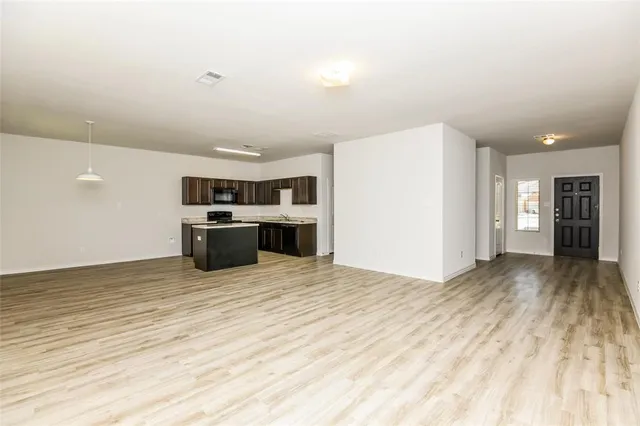 a kitchen with stainless steel appliances granite countertop a sink stove and cabinets