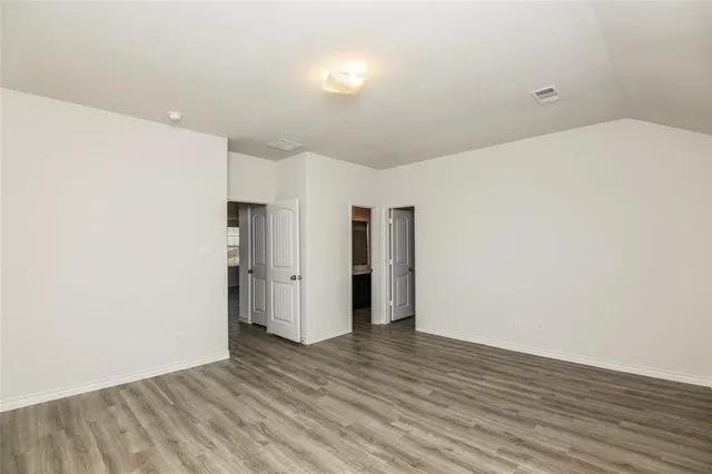 a bathroom with a granite countertop sink a toilet a mirror and bathtub