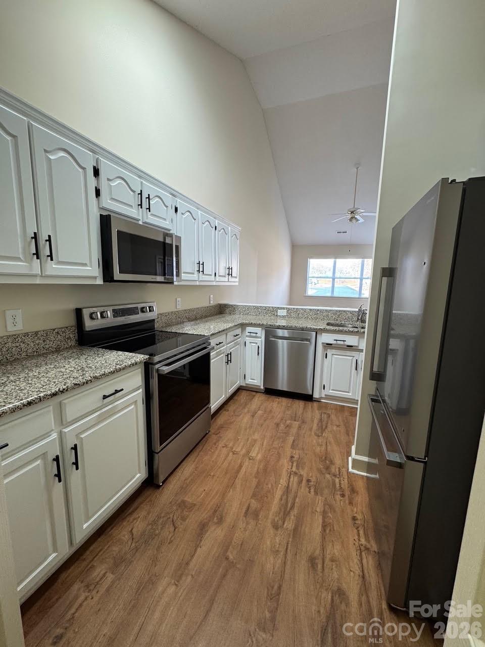 6295 Pansy Trail Denver, NC 28037 - Photo 2 of 27 a kitchen with stainless steel appliances granite countertop a refrigerator a stove top oven a sink and dishwasher