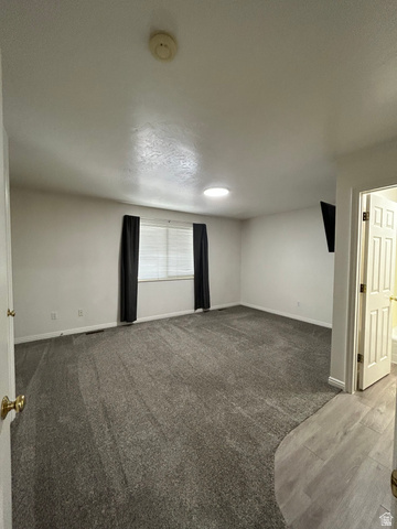 203 North Geneva Road, Unit 10 Provo, UT 84601 - Photo 13 of 16 Spacious room featuring gray carpeting and a large window with horizontal blinds