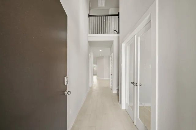 a view of a hallway with a wooden door