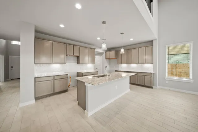 a kitchen with a sink stainless steel appliances and cabinets
